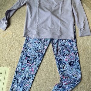Lily Pulitzer ties sweatshirt and flowered bottoms.